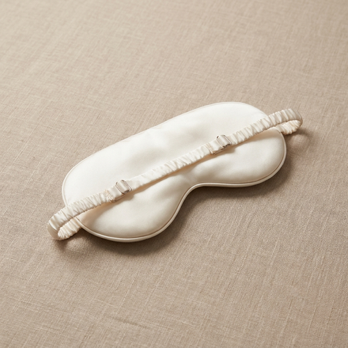 Pearl ivory silk eye mask three-quarter angle with strap detail